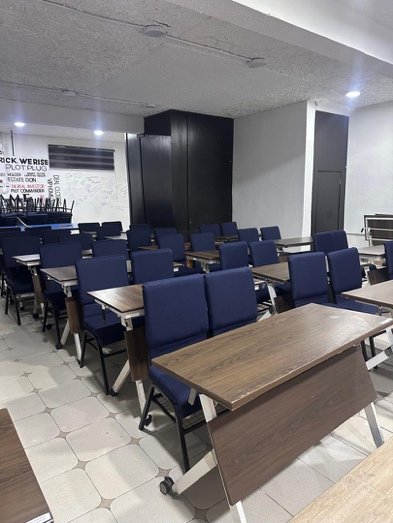 Rows of desks and blue chairs in the Ree-Hub training and event hall