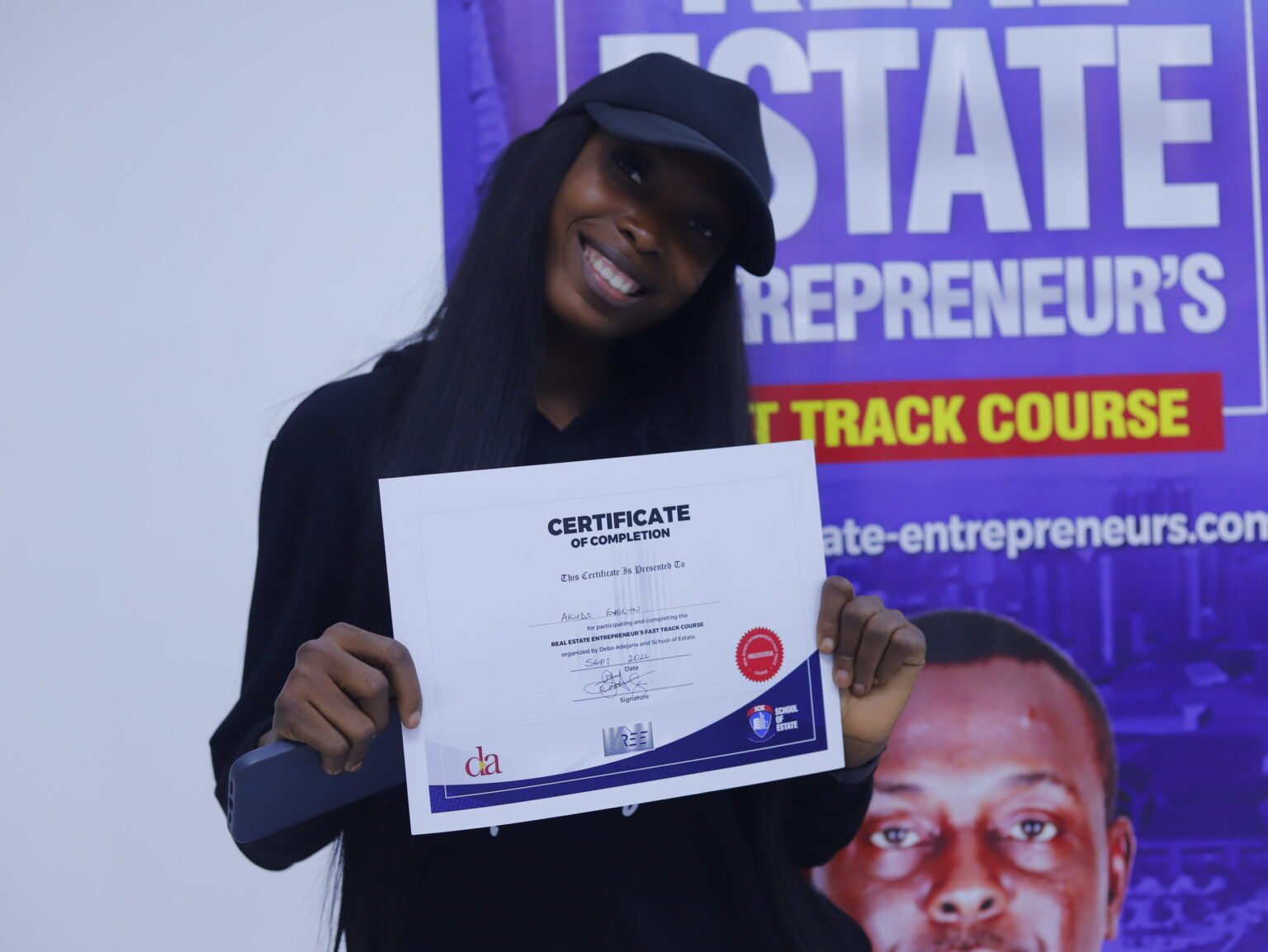 A participant holding her certificate after the training